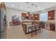 Charming kitchen features wood cabinets, stainless steel appliances, tile backsplash and island with seating at 2555 Antique Blossom Ave, Henderson, NV 89052