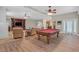 Entertain with a pool table and cozy seating, creating a warm and inviting atmosphere at 2555 Antique Blossom Ave, Henderson, NV 89052