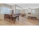 Open-concept living space with dining area, living room, and a cozy fireplace at 2555 Antique Blossom Ave, Henderson, NV 89052