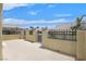 Desert home patio with tan walls, ornate black iron fence, and neighborhood views at 2555 Antique Blossom Ave, Henderson, NV 89052