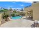Sparkling pool and spa surrounded by lush landscaping, creating a private backyard retreat at 2555 Antique Blossom Ave, Henderson, NV 89052