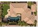 An aerial view highlights the home's terracotta roof, lush landscaping, and private pool at 2577 Luberon Dr, Henderson, NV 89044
