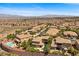 An aerial showing a hillside community with pools and desert landscaping at 2577 Luberon Dr, Henderson, NV 89044