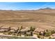 Desert homes in a neat row boast desert landscaping and mountain views at 2577 Luberon Dr, Henderson, NV 89044