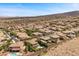 Expansive aerial view of a desert residential community with tile roofs and mountain backdrop on a clear, sunny day at 2577 Luberon Dr, Henderson, NV 89044