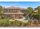 Backyard showcases the home's pool, outdoor kitchen, and lush landscaping at 2577 Luberon Dr, Henderson, NV 89044