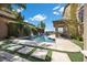Amazing backyard with a refreshing pool, lush landscaping, and a covered patio for outdoor gatherings at 2577 Luberon Dr, Henderson, NV 89044