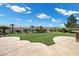 Green backyard with desert views and manicured landscaping with pavers at 2577 Luberon Dr, Henderson, NV 89044
