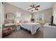 Bright bedroom featuring natural lighting, ceiling fan, and vanity and desk at 2577 Luberon Dr, Henderson, NV 89044