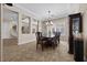 Elegant dining room with decorative chandelier and large windows at 2577 Luberon Dr, Henderson, NV 89044