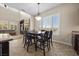 Open floor plan with a modern table, neutral couch and stone fireplace at 2577 Luberon Dr, Henderson, NV 89044