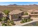 Elegant two-story home has a tile roof and desert landscaping at 2577 Luberon Dr, Henderson, NV 89044