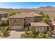 Handsome two-story home displays desert landscaping and a tile roof at 2577 Luberon Dr, Henderson, NV 89044