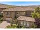 Attractive two-story home boasts a tile roof and a well-manicured front lawn at 2577 Luberon Dr, Henderson, NV 89044