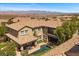 A view of the exterior showcasing the home's desert landscaping and architecture at 2577 Luberon Dr, Henderson, NV 89044