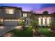 Stunning two-story home with a beautiful tile roof, lush landscaping, and a paver driveway at 2577 Luberon Dr, Henderson, NV 89044