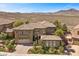 A beautifully landscaped home boasts a three-car garage and desert views at 2577 Luberon Dr, Henderson, NV 89044
