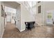 Inviting foyer with staircase and tile flooring with adjacent sitting area at 2577 Luberon Dr, Henderson, NV 89044