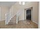 Grand foyer featuring a curved staircase, elegant tile flooring, and a stylish entrance door at 2577 Luberon Dr, Henderson, NV 89044