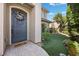Inviting front entrance with a decorative wreath, manicured lawn, and a charming walkway leading to the door at 2577 Luberon Dr, Henderson, NV 89044