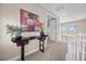 Open hallway with art and a view of the landscape from the second story windows at 2577 Luberon Dr, Henderson, NV 89044