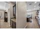 Hallway view showcases the kitchen and dining area with stylish cabinetry, countertops, and tile flooring at 2577 Luberon Dr, Henderson, NV 89044