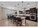 Gourmet kitchen with stainless appliances and adjacent breakfast nook at 2577 Luberon Dr, Henderson, NV 89044