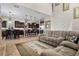Open concept living room featuring modern furnishings, neutral color palette, and staircase to the upper level at 2577 Luberon Dr, Henderson, NV 89044