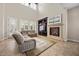 Bright living room features a cozy fireplace, built-in entertainment center, and comfortable seating area at 2577 Luberon Dr, Henderson, NV 89044