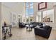 Open-concept living area with high ceilings, large windows, and comfortable seating for relaxation and entertainment at 2577 Luberon Dr, Henderson, NV 89044