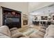 Spacious living room seamlessly connects to the kitchen and dining area, featuring a fireplace and entertainment center at 2577 Luberon Dr, Henderson, NV 89044