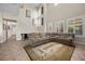 Inviting living room with a cozy sectional sofa, large windows, and a neutral color palette for a serene ambiance at 2577 Luberon Dr, Henderson, NV 89044
