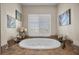Spa like main bathroom with a jetted tub and artwork at 2577 Luberon Dr, Henderson, NV 89044