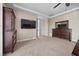 Spacious main bedroom with a large TV, tray ceilings, and neutral color scheme at 2577 Luberon Dr, Henderson, NV 89044