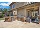 An outdoor kitchen features a built-in grill, bar area, and outdoor dining space at 2577 Luberon Dr, Henderson, NV 89044