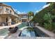 Backyard oasis features a pool, spa, and fire bowls, perfect for outdoor living at 2577 Luberon Dr, Henderson, NV 89044