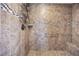 Shower features decorative tile surround, a built-in seat, and convenient storage racks at 2577 Luberon Dr, Henderson, NV 89044