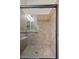 Modern bathroom shower featuring tile surround, glass doors, and built-in shelf at 2577 Luberon Dr, Henderson, NV 89044