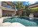 A stunning swimming pool features a water feature and lounge area in backyard at 2577 Luberon Dr, Henderson, NV 89044