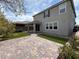 Two-story house featuring a covered patio, artificial grass, and stone block yard at 2620 Tolmezzo St, Henderson, NV 89044