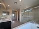 Bright bathroom with dual sinks, soaking tub and glass enclosed shower at 2620 Tolmezzo St, Henderson, NV 89044