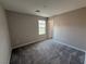 Bright bedroom featuring a window and neutral carpeting for a modern, comfortable living space at 2620 Tolmezzo St, Henderson, NV 89044