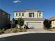 Two-story home with gray painted siding, a tile roof, and a two-car garage at 2620 Tolmezzo St, Henderson, NV 89044