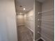 Spacious walk-in closet with ample shelving and carpeted floor at 2620 Tolmezzo St, Henderson, NV 89044