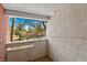 Balcony featuring stucco walls, brick pillar and a green tree view at 2643 Red Rock St # 201, Las Vegas, NV 89146