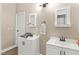 Bright bathroom with double vanities, framed mirrors, and white cabinets at 2643 Red Rock St # 201, Las Vegas, NV 89146