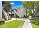 Well-maintained home exterior with green lawn, mature trees, and a private entryway at 2643 Red Rock St # 201, Las Vegas, NV 89146