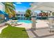 Relaxing poolside area with covered seating and lush green turf at 2643 Red Rock St # 201, Las Vegas, NV 89146