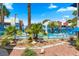 Community pool surrounded by a secure blue fence and lush palm trees at 2643 Red Rock St # 201, Las Vegas, NV 89146