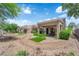 Inviting backyard features a covered patio, low-maintenance landscape, and mature trees at 2701 Glencliff Dr, Las Vegas, NV 89134